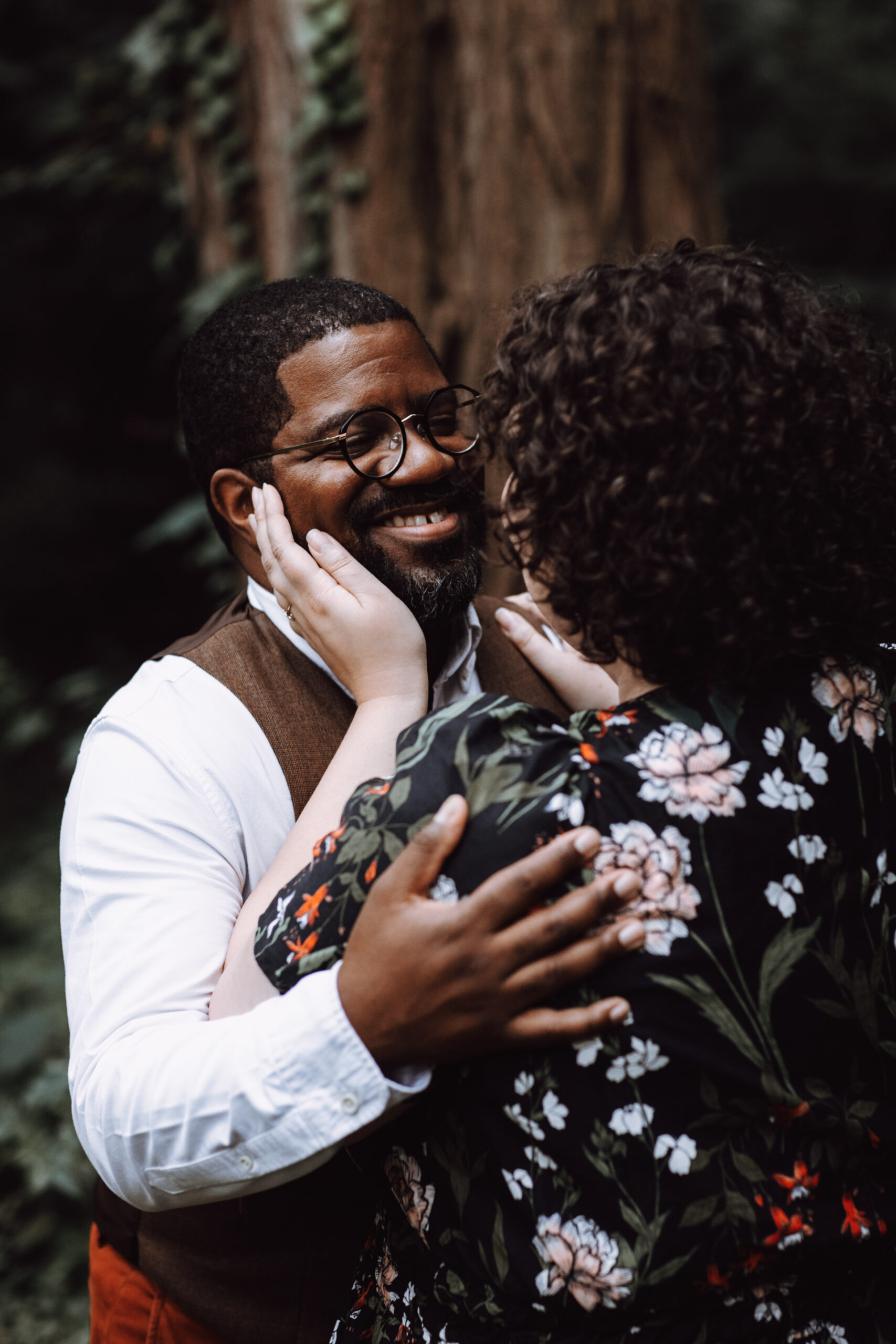 Cayla lovingly holds Windsor's face in her palm as they embrace